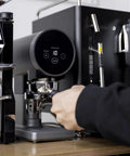 Automatic 58mm Electric Coffee Tamper With Height Adjustable Stand and Rock Solid Precision Press in use for espresso.