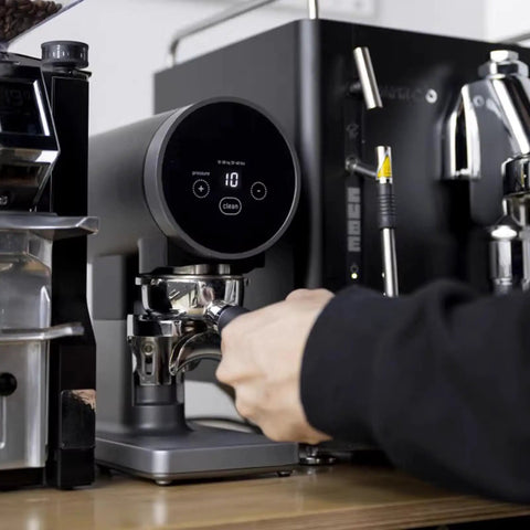 Automatic 58mm Electric Coffee Tamper With Height Adjustable Stand and Rock Solid Precision Press in use for espresso.
