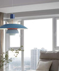 Blue UFO Style Pendant Light Dope Modern Minimalist Ceiling Fixture Aluminum Chandelier in a living room setting with city view.