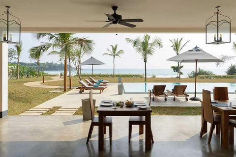 Real Deal Wet Look High Gloss Concrete And Paver Sealer For Exterior Patios Featuring Five Gallon Container on outdoor dining table with view.