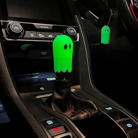 Flat Out Smooth Shifting Universal Gear Knob Featuring Glowing Phantom Etching And Contoured Machined Aluminum Handle For Easy Night Cruising Plus Three No Sweat Mount Adapters in dark car interior.