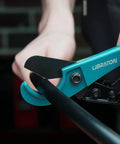 Close-up of Pex Cutter 1-1/4 Inch Pipe Cutter for PEX Tubing cutting a black plastic pipe with SK4 sharp blade