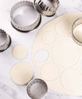 POMINEE stainless steel fluted round cookie cutter set; top-down view, sizes 2–3.5 in, scalloped edges