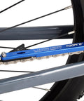 All-In-One Bike Chain Wear Gauge And Checker Tool attached to a bike chain, aluminum alloy, blue, showing wear measurement