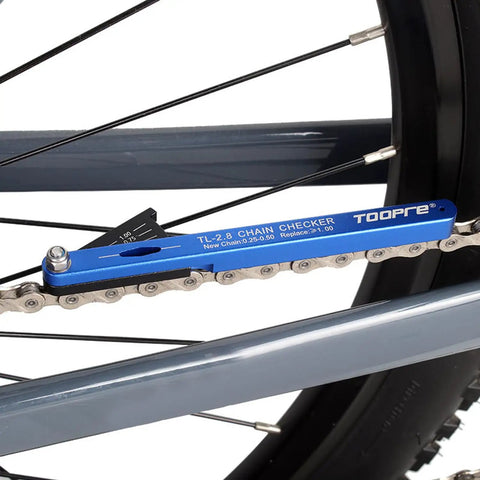 All-In-One Bike Chain Wear Gauge And Checker Tool attached to a bike chain, aluminum alloy, blue, showing wear measurement