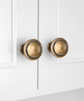 Close-up of 30 Pack Zinc Alloy Cabinet Knobs And Drawer Pulls Stepped Round Dresser Handles for kitchen cupboard in Brass Bronze finish