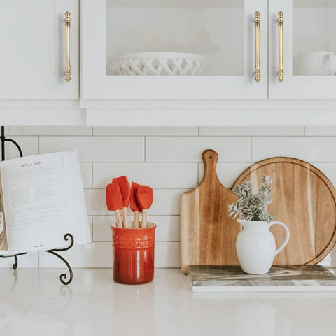 Kitchen scene with 10 Pack 5 Inch Brushed Brass Cabinet Handles 128mm Gold Kitchen Cabinet Pulls on white cupboard doors, smooth finish visible.