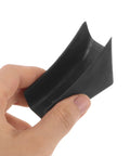 Hand holding a single black U-shaped chair leg pad, part of the 10 Pack U Shaped Chair Leg Pads With Screws For Hardwood Floors And Office Chairs.