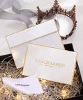 Gift box with Lancharmed Silver Jewelry branding, featuring decorative lights and a crown in the background.