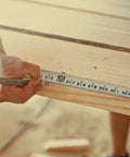 Kickin Tough 35 Foot Tape Measure Featuring Double Sided Blades And Grippy Magnetic Hook Military Hardened Composite Shell Perfect For Professional Contractors And Handyman Grind measuring wood with pencil note.