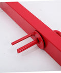 Red steel manual strap winder for trucks, close-up of crank mechanism. Hand crank cargo belt winder tool, beefy steel belt tensioner.