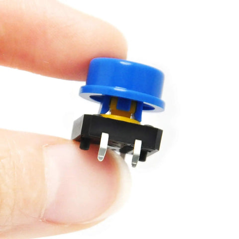 12x12x7.3mm Tactile Push Button Momentary SMD PCB Switch With Color Cap for Arduino, close-up view held by fingers