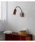 Modern Walnut Wall Sconce With 360 Degree Swivel Spotlight Brings Chill Vibes To Bedrooms And Living Rooms While Delivering Smooth Adjustments For Aisles That Makes Installation A Breeze Today, mounted on a wall.