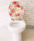 Stylish Floral Design Resin Soft Close Toilet Seat Featuring Smooth Damping Hinges And No Sweat Quick Mount Universal Fit For Most Standard Oval Restrooms Up To 48 Cm Long on white toilet.