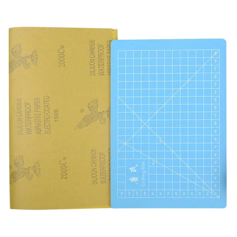 Sandpaper and blue cutting mat from 56 Piece Model Tools Kit For Gundam And Car Models A Complete Do It Yourself Hobby Craft Set.