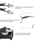 Close-up of Soldering Helper Arm With 3X Magnifying Lamp showing flexible clips, angle joints, and storage tray for electronics work.