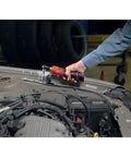 Top Shelf M12 Cordless 3/8 Inch Drive Ratchet Tool With One Point Five Amp Hour Red Lithium Battery Pack in use on a car engine.