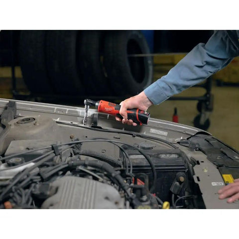 Top Shelf M12 Cordless 3/8 Inch Drive Ratchet Tool With One Point Five Amp Hour Red Lithium Battery Pack in use on a car engine.
