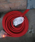 Coiled Beefy Heavy Duty Outdoor Indoor Extension Cord 75 Feet With 10 Gauge 3 Outlet Lighted SJTW 125V 15 Amp on concrete floor