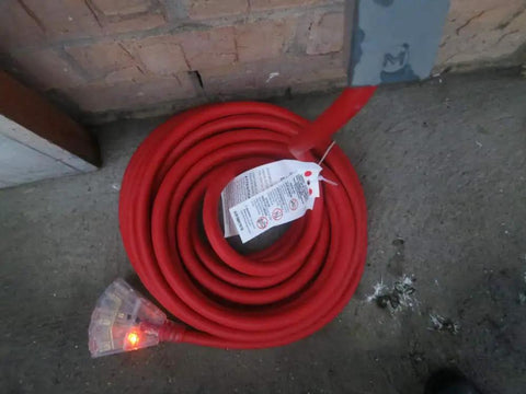 Coiled Beefy Heavy Duty Outdoor Indoor Extension Cord 75 Feet With 10 Gauge 3 Outlet Lighted SJTW 125V 15 Amp on concrete floor