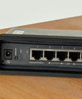 Heavy Duty 19 Inch Rack Mount Bracket For MikroTik Hap AC2 Router Featuring Secure Screw In Hardware That Fits Like A Glove For Slick 1U Server Cabinet Setups Built To Rock Your Network Game Today, front view showing ports and power connections.