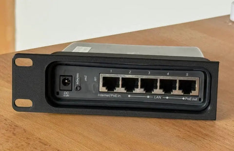 Heavy Duty 19 Inch Rack Mount Bracket For MikroTik Hap AC2 Router Featuring Secure Screw In Hardware That Fits Like A Glove For Slick 1U Server Cabinet Setups Built To Rock Your Network Game Today, front view showing ports and power connections.