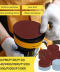 Close-up of gloved hand placing sanding disc on tool from 131Pcs 3 Inch Sanding Disc Drill Polishing Kit With Attachments For Drill Grinder Rotary Tools Dry Wet Headlight Restoration Car Polishing Glass Finishing Scum Removal Pro Grade DIY Buffing Kit.
