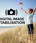Young boy enjoying the beach while holding a pinwheel, showcasing A Real Deal 16 Megapixel Digital Camera With 5X Optical Zoom.