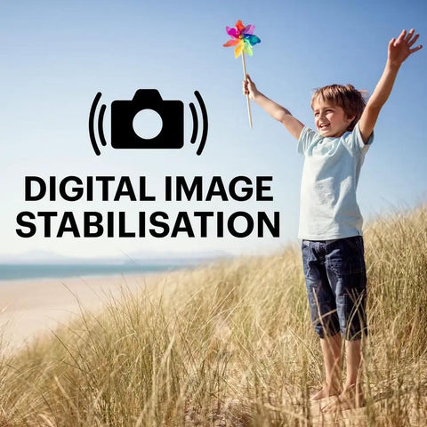 Young boy enjoying the beach while holding a pinwheel, showcasing A Real Deal 16 Megapixel Digital Camera With 5X Optical Zoom.