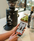 Barista Level Electric Coffee Grinder With Stepless Control And 54Mm Steel Flat Burrs delivers consistent grounds next to a smartphone app.