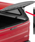 No Fuss 12 Inch Gas Strut Lift Kit For Camper Shells mounted on a red truck cap, showcasing the gas strut mechanism and lid support.