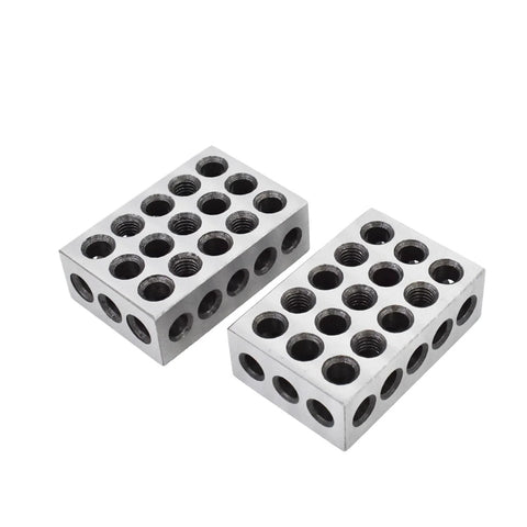 Two aluminum 1-2-3 machinist blocks with multiple threaded holes for precision milling jig