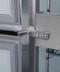 Close-up of the stainless steel hinge on the Badass Heavy Duty Commercial Reach In Refrigerator featuring four solid doors.