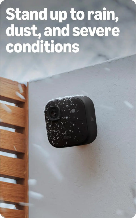 Top Tier Wireless Home Security Bundle With Crisp 2K Plus Outdoor Camera And Reliable Video Doorbell mounted outdoors with snow.
