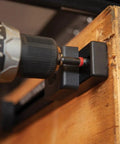 Tradesman Pro Modular Drill Pouch With Belt Clip For Click Lock System attaching to wooden board with drill bit