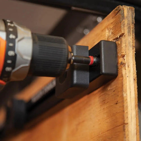 Tradesman Pro Modular Drill Pouch With Belt Clip For Click Lock System attaching to wooden board with drill bit