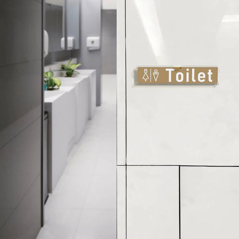 Toilet sign with icons mounted on wall in modern restroom