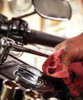 Hand using Three Eighths Inch Drive Six Point Socket Set on motorcycle with chrome polish finish, corrosion resistant, large markings.