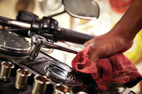 Hand using Three Eighths Inch Drive Six Point Socket Set on motorcycle with chrome polish finish, corrosion resistant, large markings.