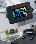 Hella Precise Pure Copper Shunt Battery Monitor Tracks 0 To 100 Amps Across 8 To 120 Volt Systems Featuring A Badass 32 Bit Chip And Usb Data Logging Plus Bidirectional Measurement For Solar Projects And RV Camper Builds, LCD screen displaying voltage and current.