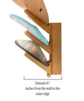 Side view of The Sun Rack Premium Bamboo Wall Mount For Surfboards Snowboards Skis And Wakeboards Holds Four Boards With Built In Drawer And Hooks For Garage And Home Storage Dope Space Saving Display And Organization, showing three boards secured.