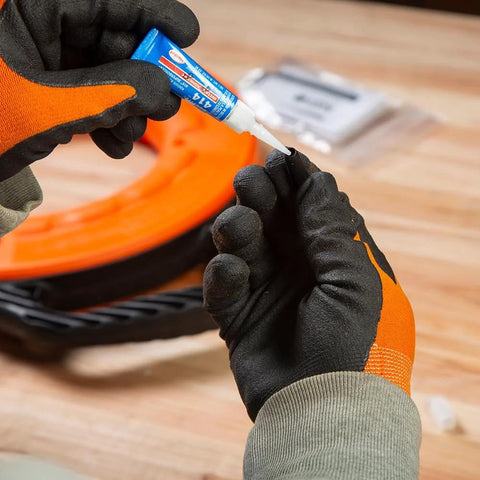 Klein Tools 56025 non-conductive fish tape repair kit, close-up of blue glue being applied to a repair part