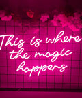 Where The Magic Happens Neon Sign Wall Decor 23 Inch LED Neon Light for Bedroom Bar Party with pink glow on grid wall