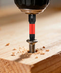 Close-up of a 43 Piece Screwdriver Bits Set With Nut Drivers, Socket Adapters and Magnetic Bit Holders drilling into wood.