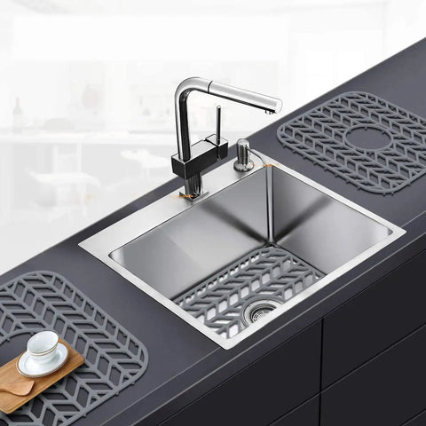 Silicone Sink Protector Mat for Kitchen Sink Grid With Raised Feet Non Slip Cushion in gray on a stainless steel sink.
