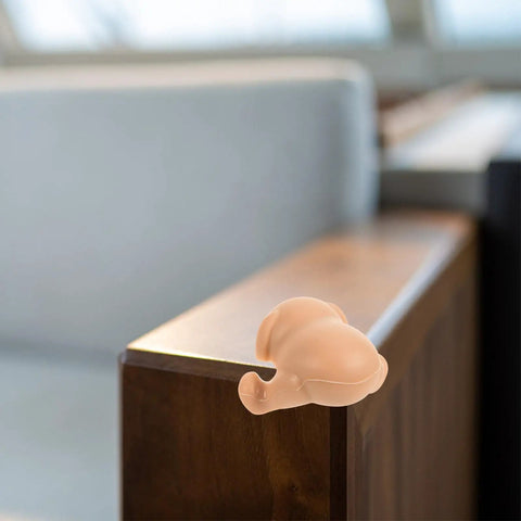 Dog and Bear Shaped Silicone Table Corner Protectors on wooden table, anti collision corner guards for furniture safety, childproofing