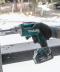 Hand holding 18V LXT Brushless Cordless Drywall Screwdriver Bare Tool With Push Drive Technology And Lock On Mode Delivers 0 To 4000 RPM