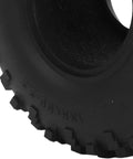 Close-up of rugged black tire surface showing textured tread pattern and sidewall details, suitable for electric bikes and scooters.