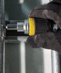 Compact Six In One Stubby Ratcheting Screwdriver With Phillips And Slotted Bits Plus One Quarter Inch And Three Sixteenth Inch Nut Drivers Cushioned Grip For Maximum Torque And Comfort Pro Grade Ideal For Tight Spots From Klein Tools being used in tight space