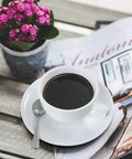 Demitasse Espresso Spoon Set Of 6 next to coffee cup on magazine, mini stainless steel coffee spoons for tea dessert and after dinner